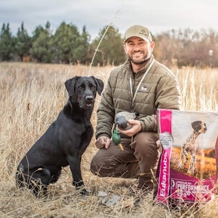 Brad Arington with black Lab and Eukanuba Premium Performance 30-20 Sport